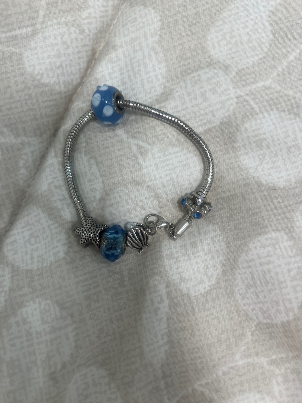 Silver Bracelet with Blue Glass and Charm Accents